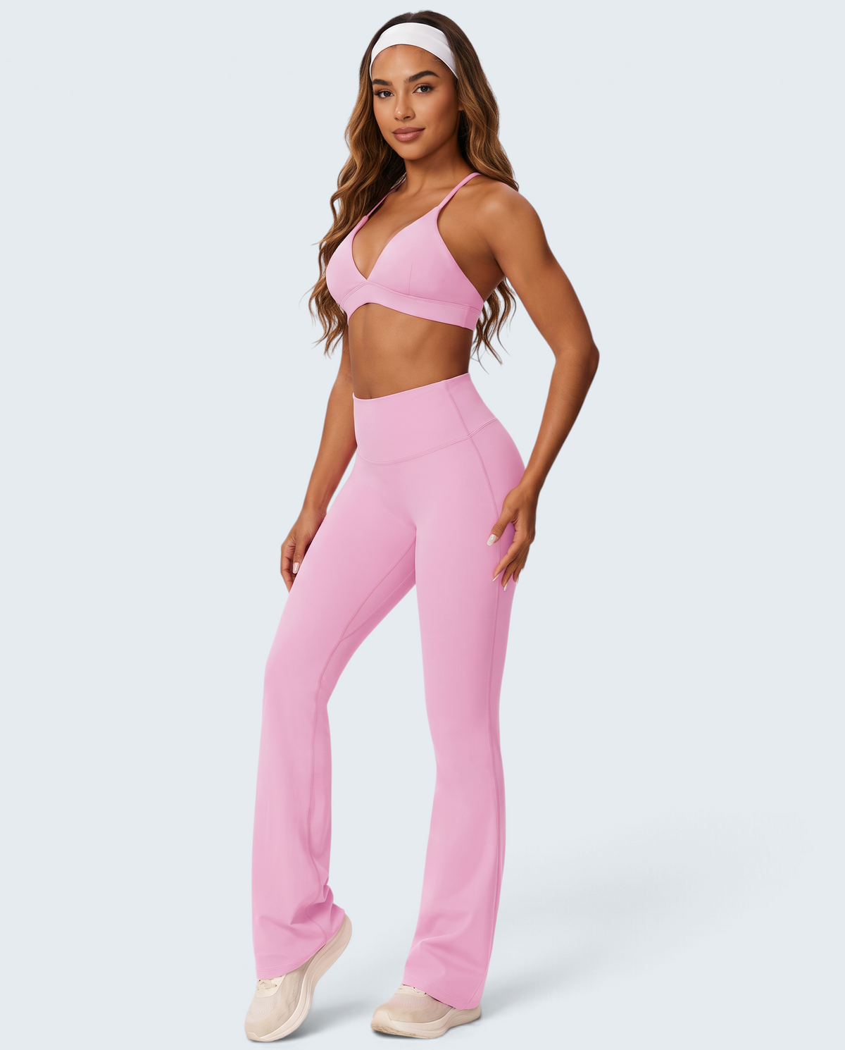 Modelo veste conjunto rosa de top e calças flare VD Beyond Limits em malha suave, ideal para desporto e lazer.